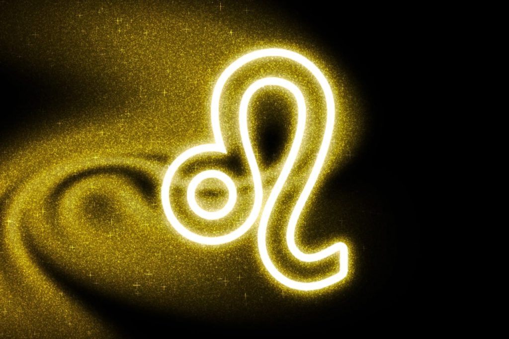 Sternzeichen Löwe als leuchtendes, goldenes Symbol auf dunklem Hintergrund mit glitzernden Partikeln